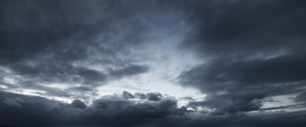 The sky with many large dark storm clouds.